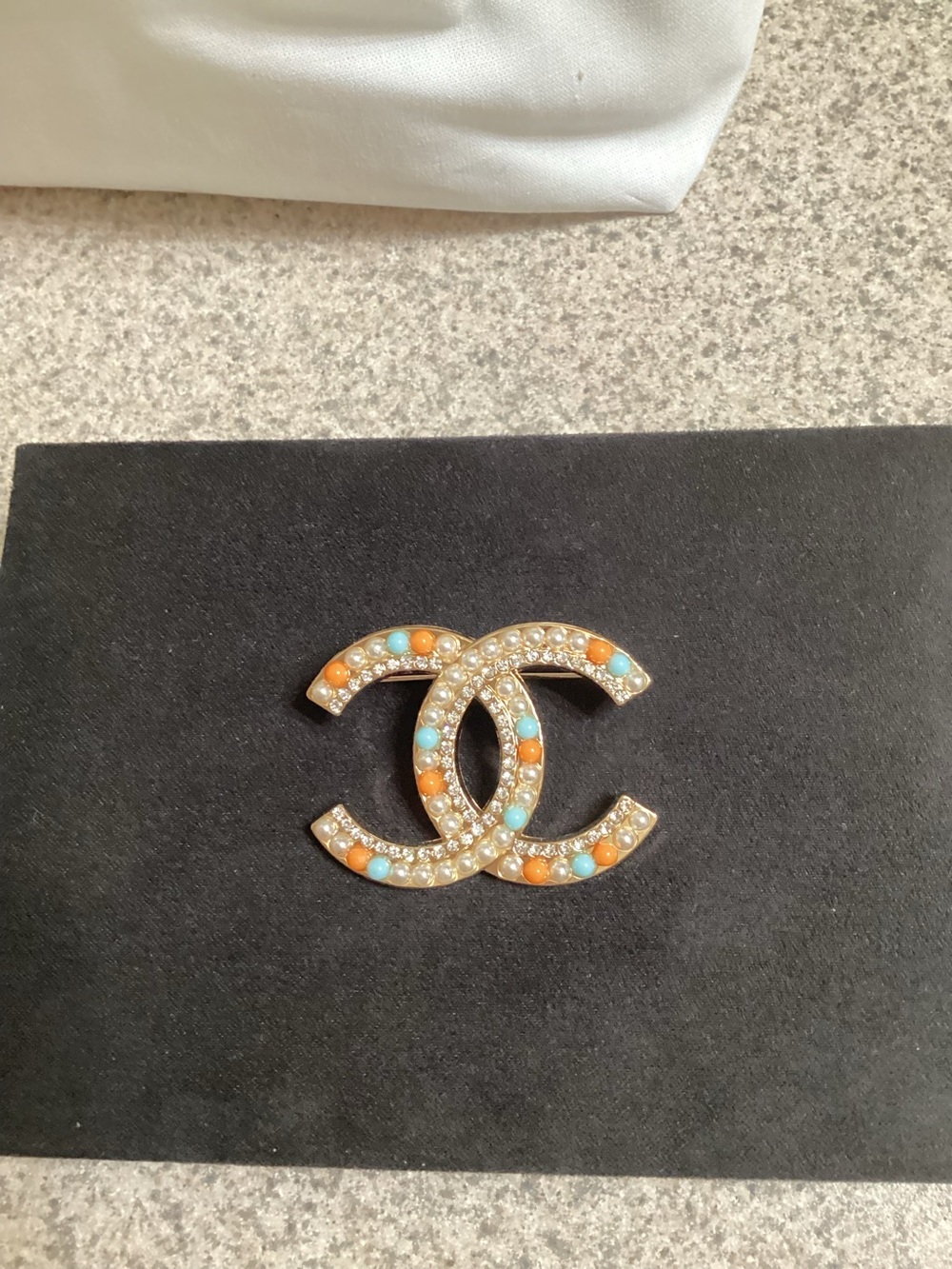 Chanel Interlocking CC Pearl Brooch with Turquoise and Orange Accents.